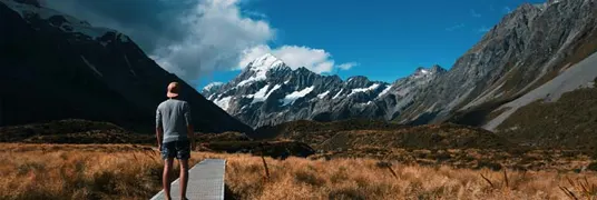 A man walking through a mountain range