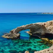 A rock formation in blue sea