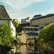 White and brown concrete buildings beside the river