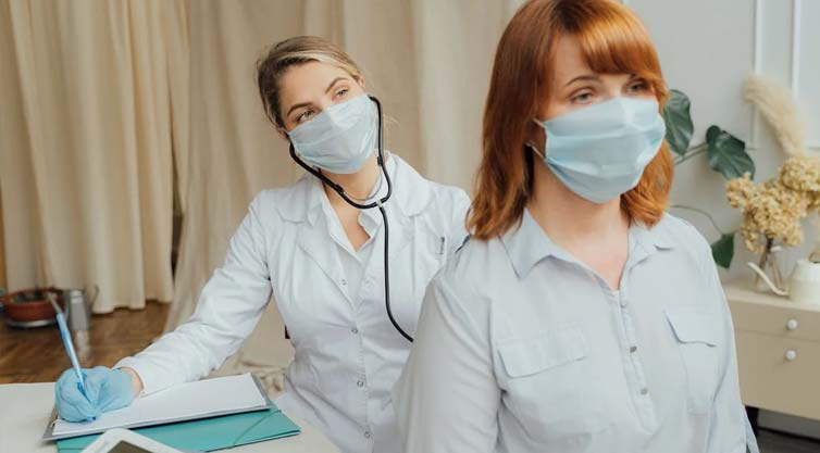 Woman in face mask visiting doctor