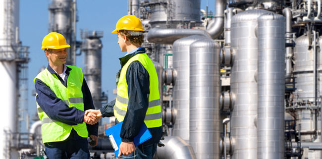 Two men in PPE shaking hands