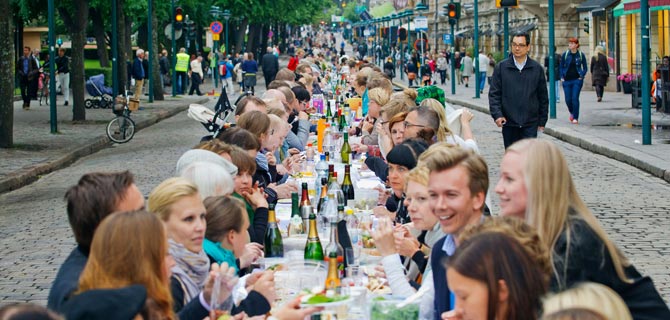People enjoying a feast on a public road