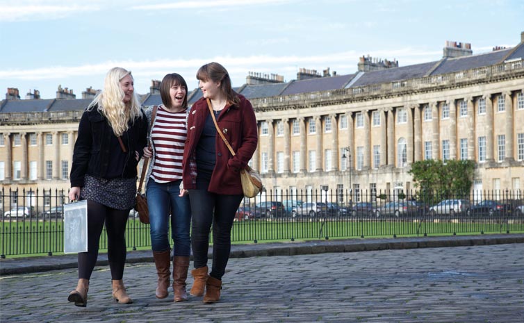 Three students walking in the city of Bath