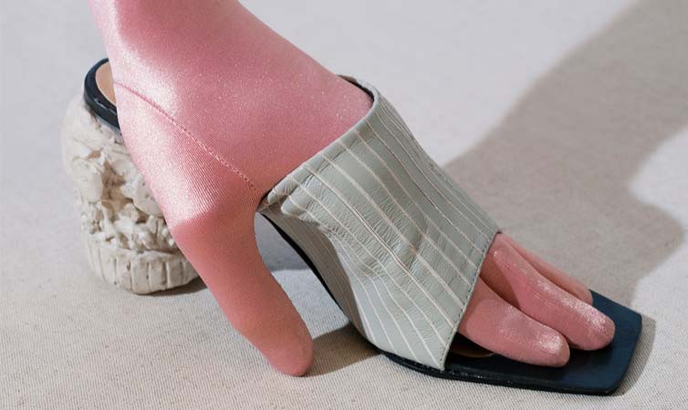 A shoe design with a hand in it