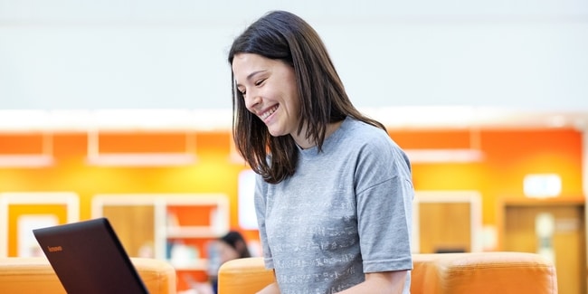 Smiling student with laptop