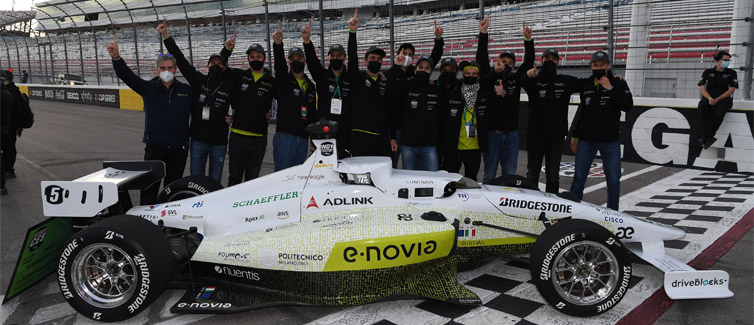 Students pose with open seat racing car