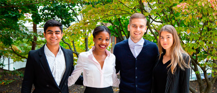 Four students dressed in smart clothing