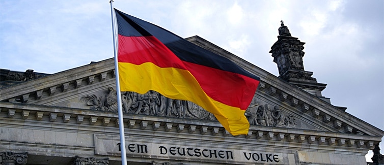 Flag of Germany in front of a grey building