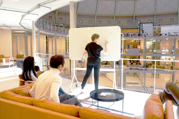 Students drawing on a whiteboard