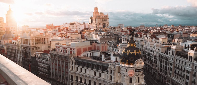 Photo of the city skyline of Madrid with sunrise in background