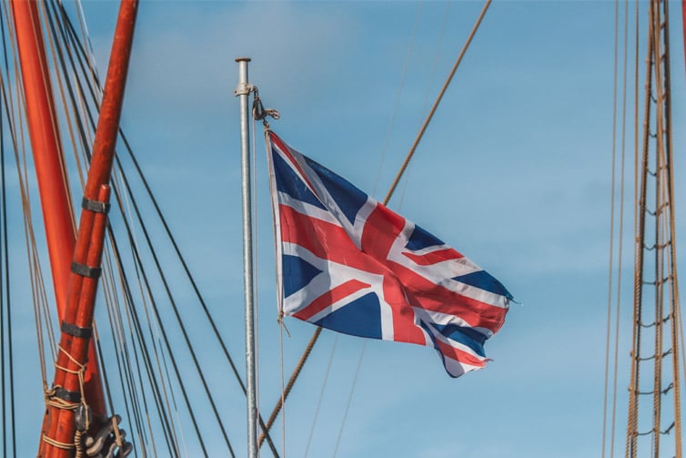 Image of the UK flag flying on a flagpole on a ship
