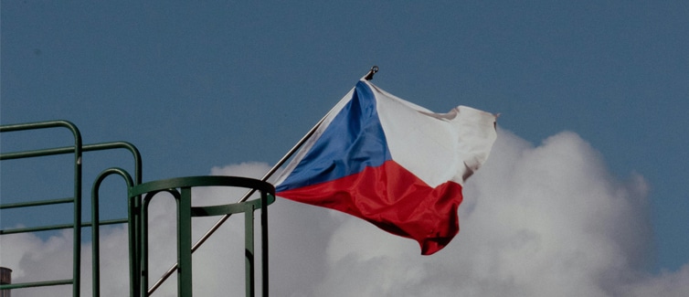 Image of a red, white and blue Czech Republic flag on a flagpole