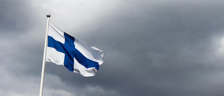 Image of a blue and white Finland flag on a flagpole
