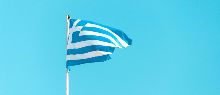 Image of a blue and white Greece flag on a flagpole