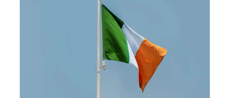 Image of a green, white and orange Irish flag on a flagpole