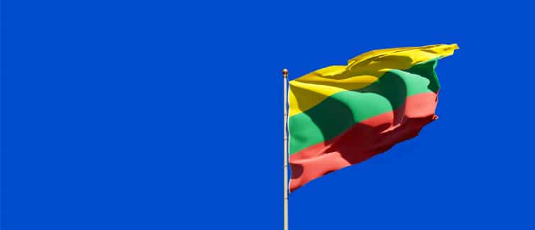 Image of a yellow, green and red Lithuania flag on a flagpole
