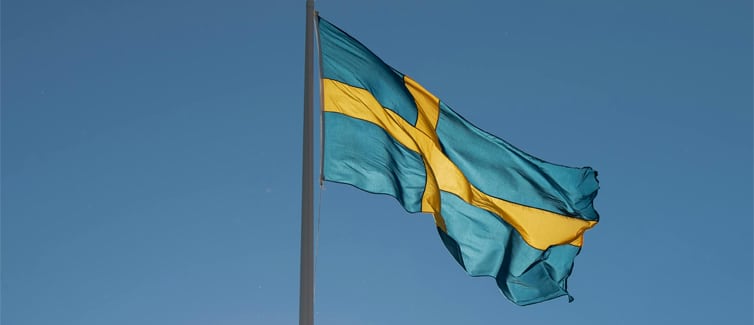 Image of a blue and yellow Sweden flag on a flagpole