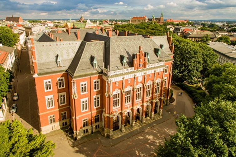 A large red brick building surrounded by trees