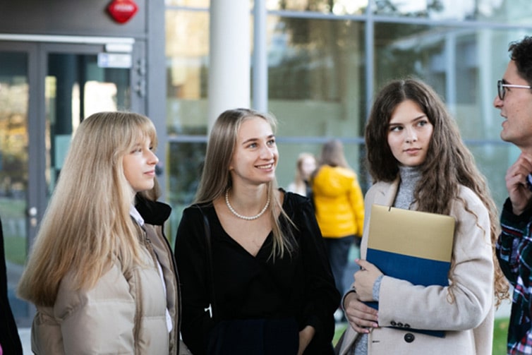 4 students looking at each other during a conversation