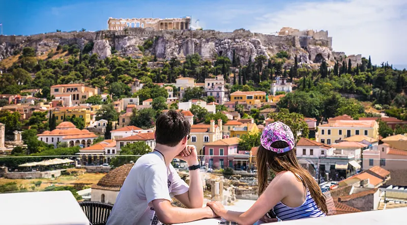 Couple holding hands looking at scenery