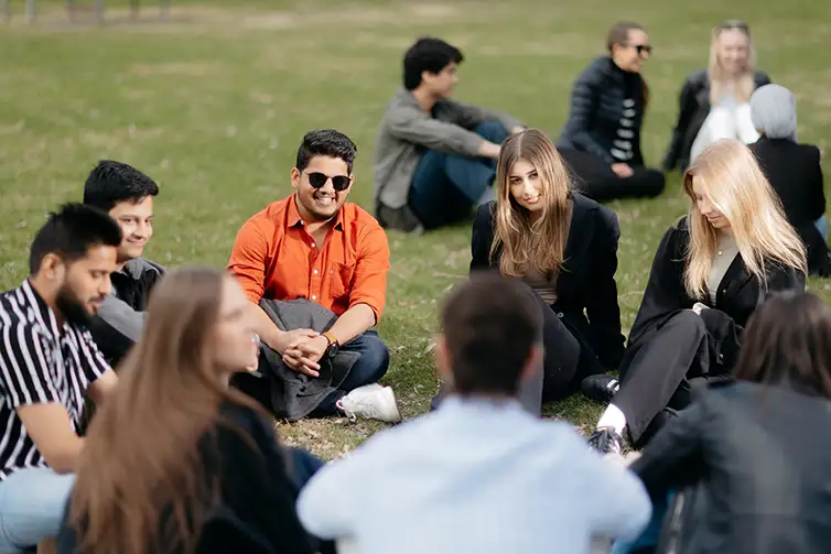 People sat on grass in a circle