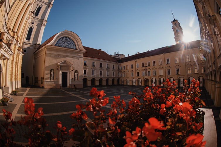 An image of a beautiful sandstone building surrounding a courtyard