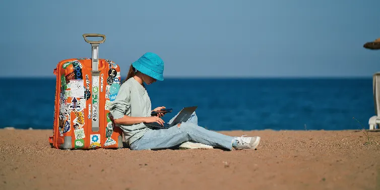 Lady reading a book on a beach