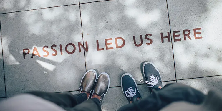 View of two pairs of shoes next to motivational slogan