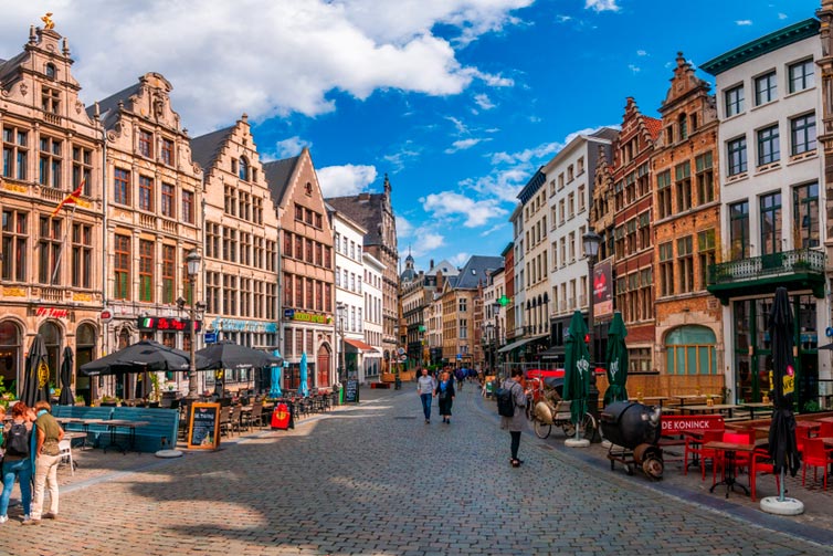 Image of a street lined by traditional Belgian style buildings and restaurants